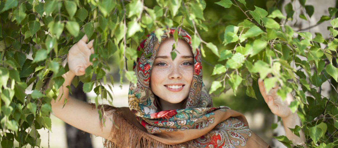 Russian beauty woman in the national patterned scarf