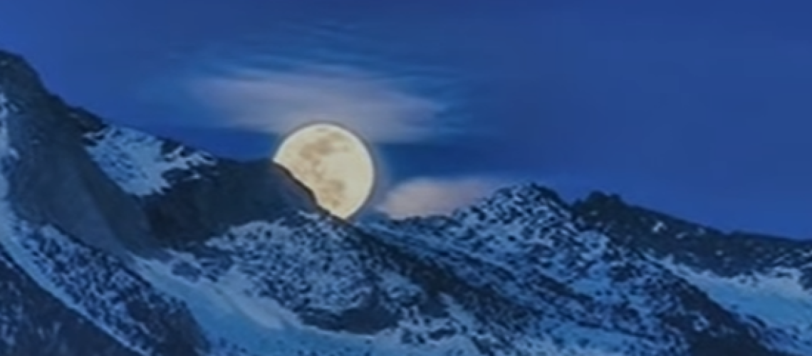 full moon over snow mountains
